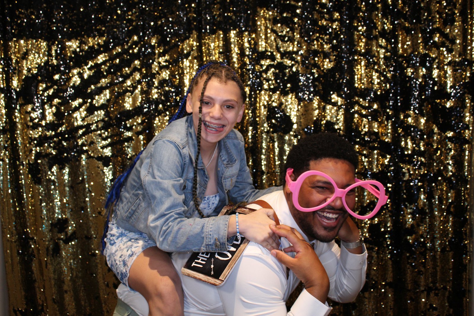Family having fun with photo booth props at a wedding